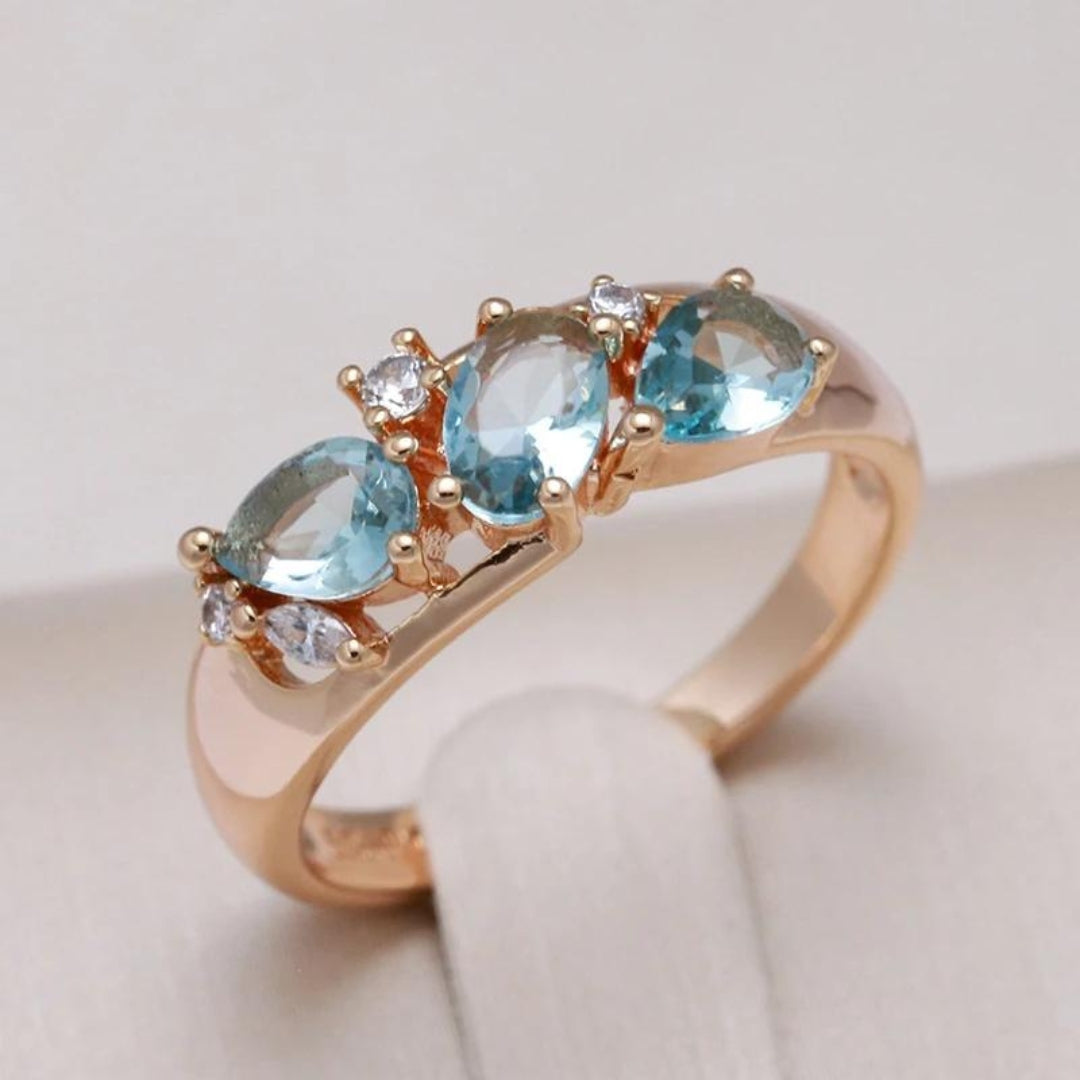 Gold ring with blue zirconia stones