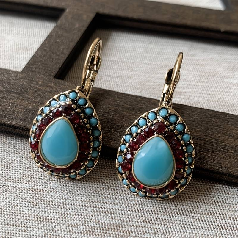 Golden earrings with blue opal drop
