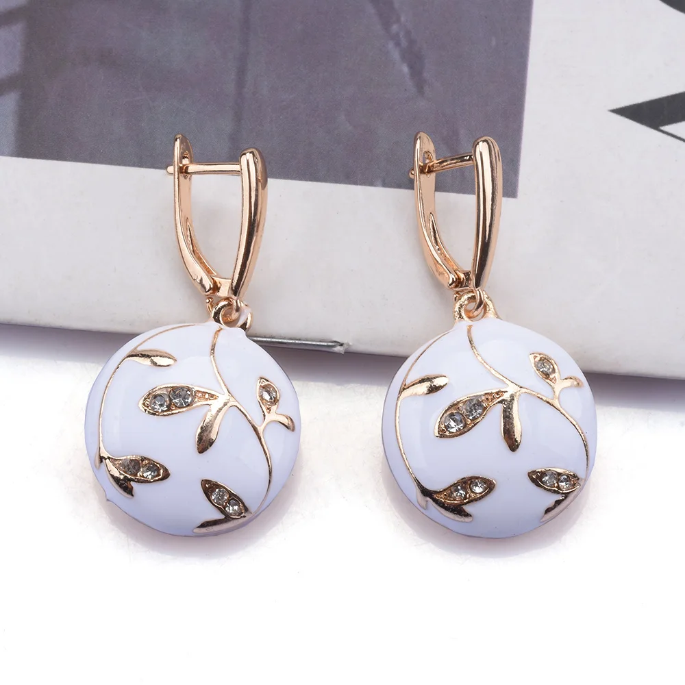 Vintage earrings with white enamel and golden details