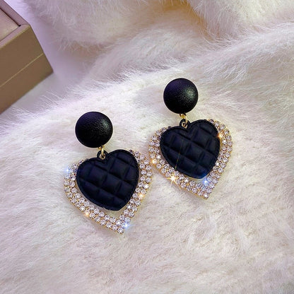 Gold earrings with dark heart