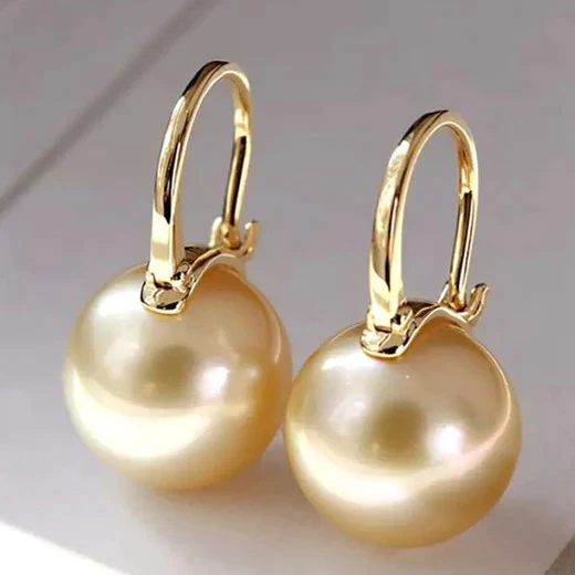 Elegant gold earrings with golden pearls