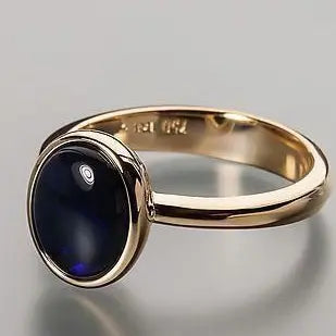 Golden ring made of dark glass