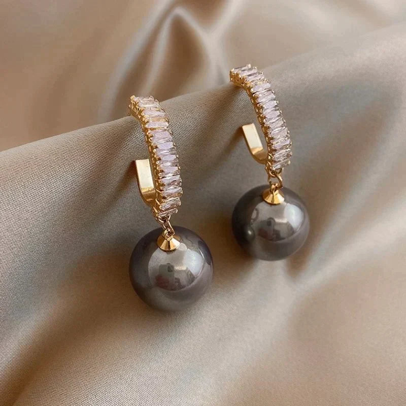 Luxury earrings with a stylish pearl and zirconia