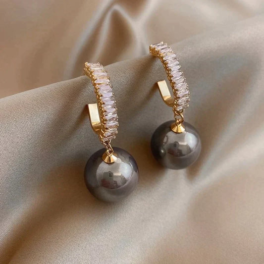 Luxury earrings with a stylish pearl and zirconia