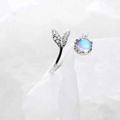 Adjustable ring with dolphin tail made of sterling silver and blue zirconium dioxide